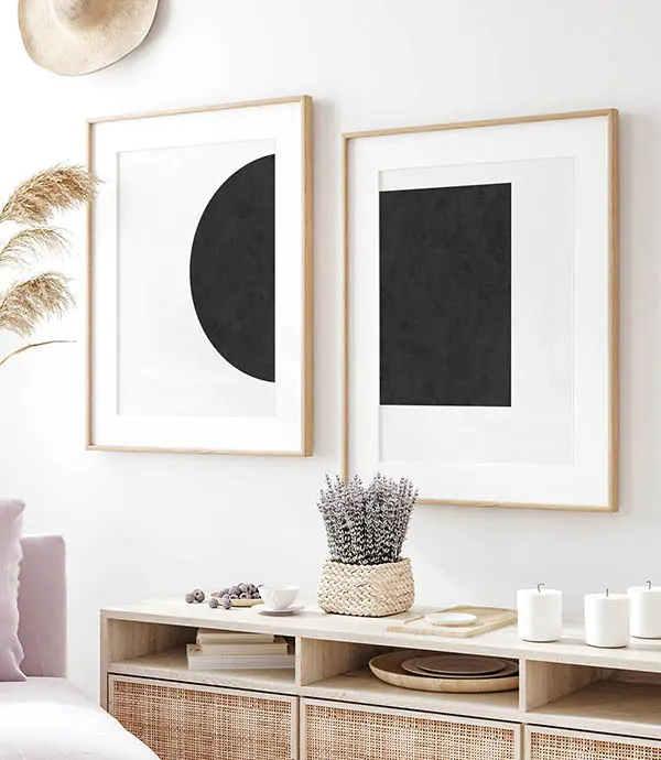 Minimalist geometric wall art set featuring black abstract circle and square prints in light oak frames