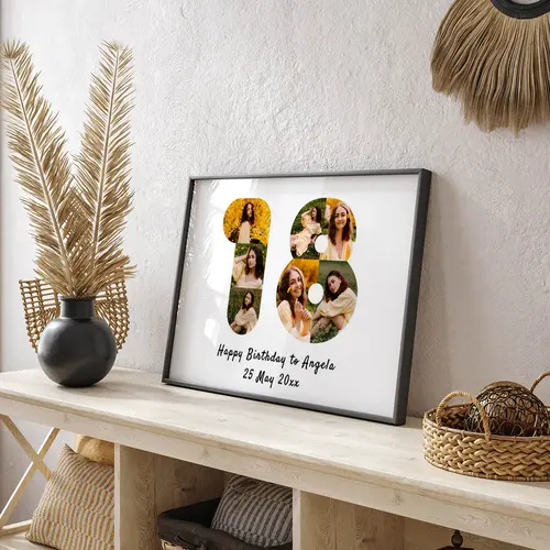 Birthday number wall art print featuring personalised photos in black frame on wooden table
