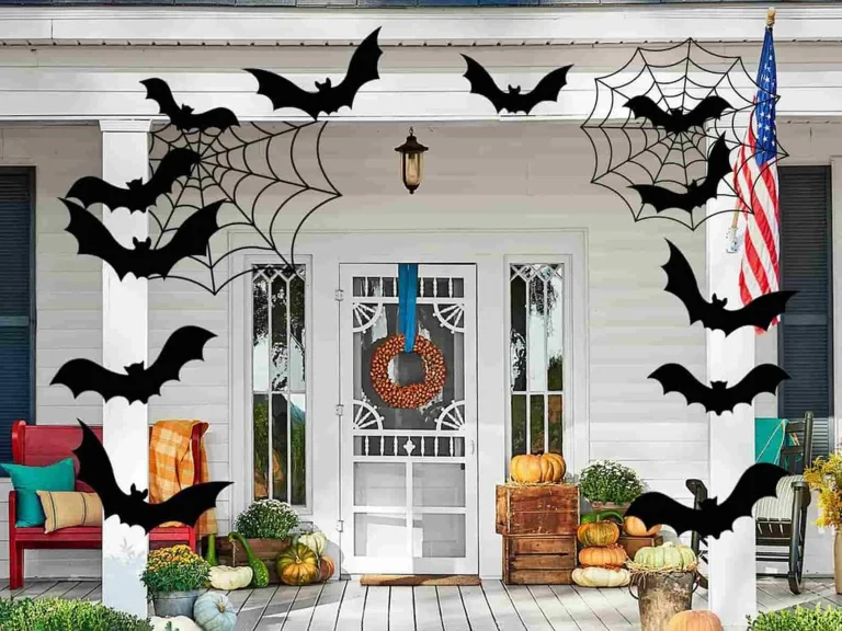 Front porch decorated with black bats and spider webs for Halloween
