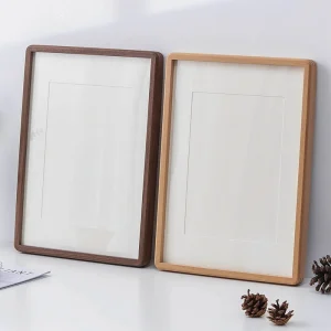 Beechwood and Walnut photo frames standing side by side on a white surface