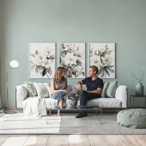 Three matching framed floral prints styled above a living room sofa
