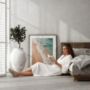 Framed beach photograph leaning against the bedroom wall