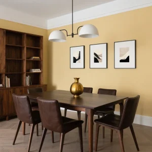 Modern abstract art prints styled as a set of three above a walnut dining table in a contemporary Australian home.
