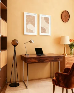 Minimalist line art prints in white frames styled above a timber desk in a warm home office setting.