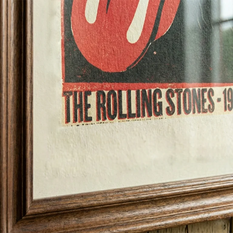 Close-up of a framed poster print showing fine paper texture and timber frame detail.