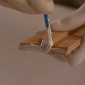applying wood adhesive to a timber frame corner during wooden picture frame making
