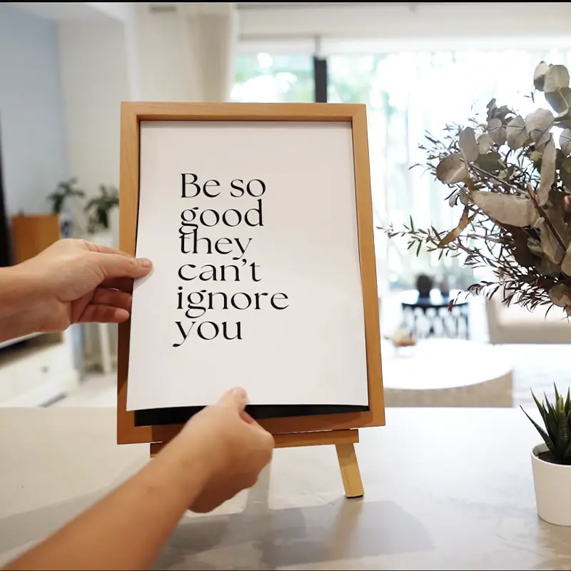 Swapping a motivational print on a VeeArt magnetic photo frame