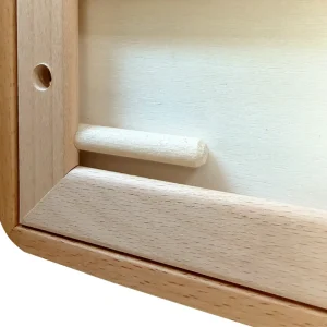 Close-up detail of the wooden support dowel stored inside the frame's backboard groove.