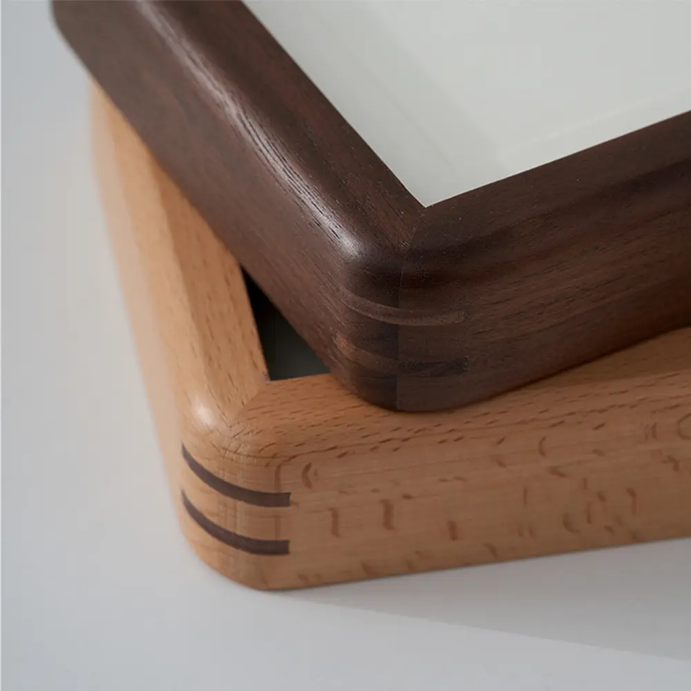 Comparison of Veeart walnut and beech wood frames showing exquisite spline joinery on rounded corners.