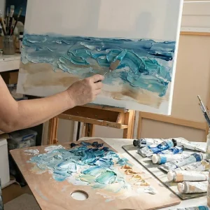 Artist hand painting Surfers Dream with acrylic paint texture