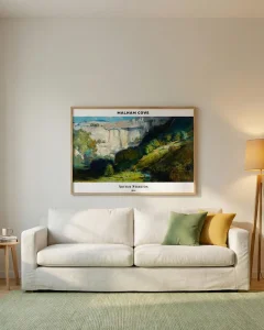 Horizontal landscape art by Arthur Streeton hanging 15-20cm above a light beige sofa in a cozy living room.