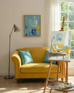 Framed abstract art displayed next to a painter's easel.
