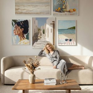 Gallery wall with multiple thin metal picture frames in contemporary dark living room.