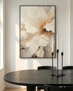 Large floral abstract art in gold metal frame above marble dining table in luxury setting.